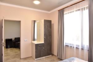 a bedroom with a dresser and a mirror at ABA Resort in Gyulagarak +39 photos