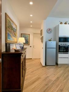 a kitchen with a counter and a refrigerator in it at La Casa dei Nonni in Levanto