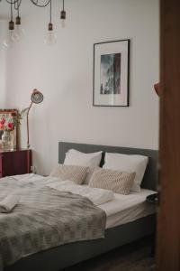 a bed with white sheets and pillows in a bedroom at Gallery Apartment 2 in Martin +15 photos