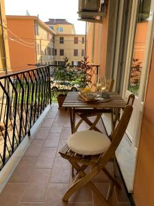 a table and chair on a balcony with a view at La Casa dei Nonni in Levanto