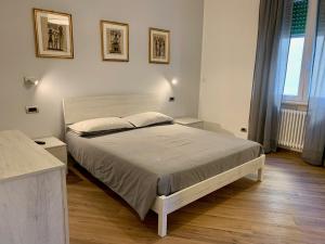 a bedroom with a large bed and two pictures on the wall at La Casa dei Nonni in Levanto