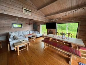 a living room with a couch and a table at Cosy and authentic cabin in Lofoten in Sandsletta
