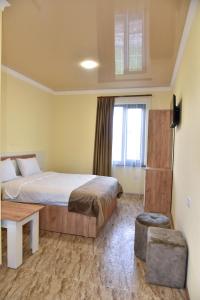 a bedroom with a large bed and a window at ABA Resort in Gyulagarak
