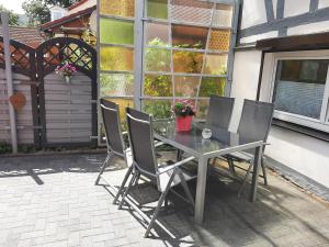 a table and chairs sitting on a patio at Ferienwohnung Alte Glaserei in Ilsenburg
