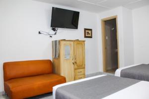 TV a/nebo společenská místnost v ubytování Hotel Poblado Suite