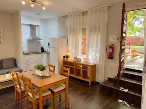 a kitchen and dining room with a table and chairs at Apartamentos Caspe in Caspe