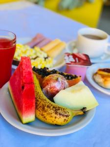 a plate with a banana and fruit on a table at Pousada Casa Do Mar in Paraty