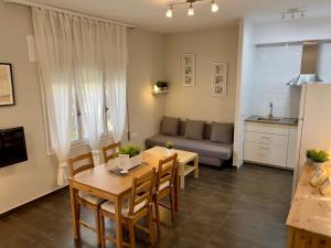a living room with a table and a couch at Apartamentos Caspe in Caspe
