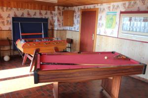 two billiard tables in a room with a pool table at appartement mitoyen dans chalet in Fraize