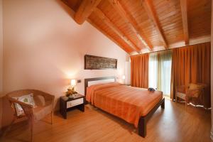a bedroom with a bed and a chair at La Casa del Nonno in Monzambano +71 photos