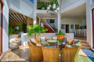 a dining room with a table and chairs at Adventure House Conchas Chinas in Puerto Vallarta
