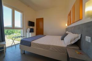 Postel nebo postele na pokoji v ubytování Hotel Rivabella