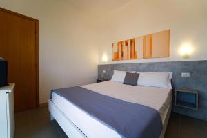 Postel nebo postele na pokoji v ubytování Hotel Rivabella