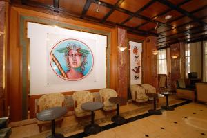 a living room with a large mural on the wall at Balasca Hotel in Athens