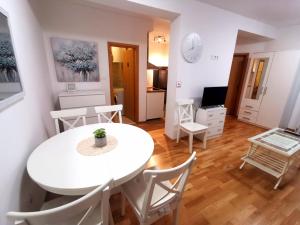 a living room with a white table and chairs at Apartment Tatiana in Dubrovnik