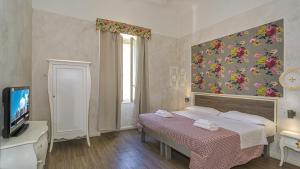Postel nebo postele na pokoji v ubytování B&B Relais Inn Lucca