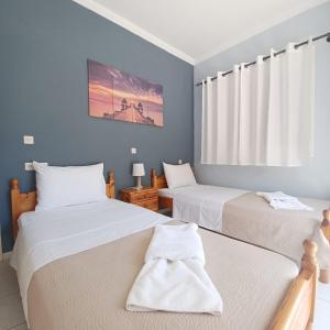 A bed or beds in a room at Μπουκαμβίλια - Bougainvillea