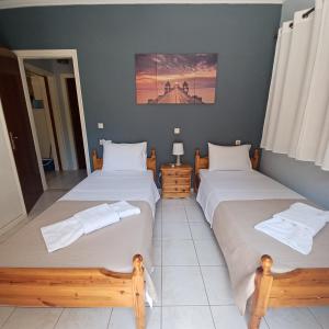 A bed or beds in a room at Μπουκαμβίλια - Bougainvillea