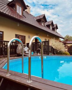 a house with a swimming pool in front of a house at Bohdanečská chalupa in Bohdaneč