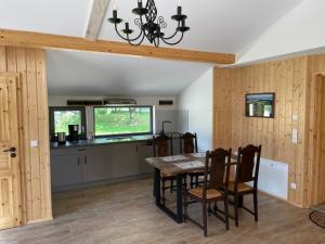 a kitchen and dining room with a table and chairs at Ferienwohnung-Ferienhaus am Picho in Arnsdorf +7 photos