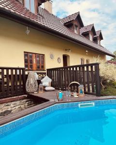 a swimming pool in front of a house at Bohdanečská chalupa in Bohdaneč