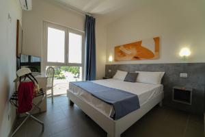 Postel nebo postele na pokoji v ubytování Hotel Rivabella + 37 fotografií