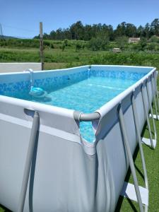 a swimming pool on the back of a house at CASA ABUELA MERCEDES in César