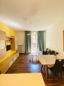 a living room with a table and a couch at appartmentslapiazzetta -1-2-6 in Sesto Calende