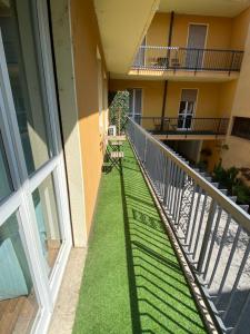 a balcony of a building with green grass at appartmentslapiazzetta -1-2-6 in Sesto Calende