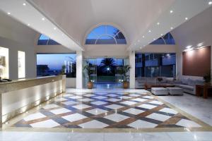 a lobby with a checkered floor and large windows at Avra Beach Resort in Ixia