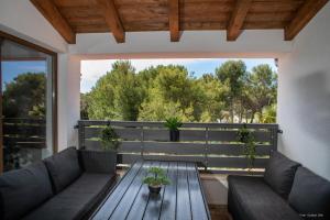 a living room with a wooden table on a balcony at Apartment "Istra Inspirita" in Rovinj