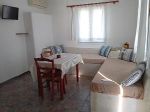 a living room with a table and a couch at Aegean Sunset in Kionia