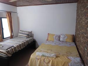 a small bedroom with a bed and a window at Casa Puerto Triunfo Dann in Puerto Triunfo +28 photos