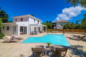 a villa with a swimming pool and a house at Villa Ionio Deste by Villa Plus in Vasilikos