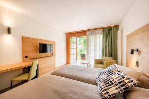 a hotel room with two beds and a desk at I Grappoli in Sessa +37 photos