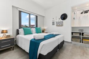 a bedroom with a large bed and a window at Dreamy 2 bed apartment by the sea in Paphos
