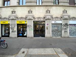a building with graffiti on the front of it at Richard's Apartments - 22 Marzo in Milan