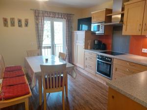 a kitchen with a table and a table and chairs at Schlaferhof - Urlaub am Bauernhof in Fresach