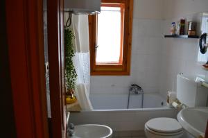a bathroom with a tub and a toilet and a sink at La baita di Pan in Pizzoferrato +28 photos