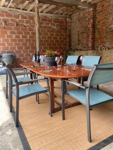 una mesa de madera y sillas con copas de vino. en No. 5 Plaisance, en Plaisance