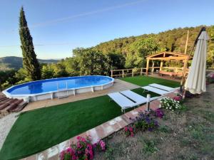 a backyard with a swimming pool and a lawn at Sunset Valley - A Tuscan Experience in Civitella in Val di Chiana