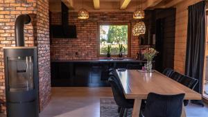 a kitchen and dining room with a brick wall at Apartament Sasinowe Zacisze in Sasino