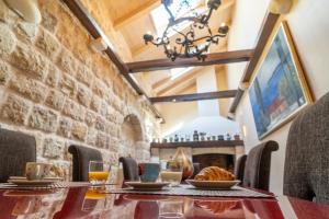 a dining room with a table with food and drinks at Villa Revelin Dubrovnik Old Town in Dubrovnik