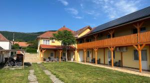 a house with solar panels on the side of it at Montana-Ederics Vendégház in Balatonederics