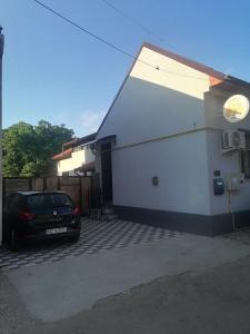 a car parked in a parking lot next to a building at Happy House in Hunedoara