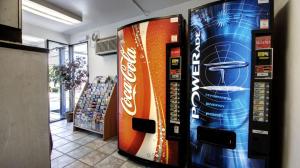 a vending machine filled with soda cans in a store at Super 8 by Wyndham Woods Cross - Salt Lake City North in Woods Cross