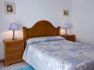 a bedroom with a bed and two night stands at Hotel Restaurante Xaneiro in Melide