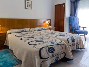 a bedroom with a bed with a blanket on it at Hotel Restaurante Xaneiro in Melide