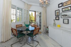 a dining room with a glass table and chairs at Cute apartment oceanfront in Benalmádena
