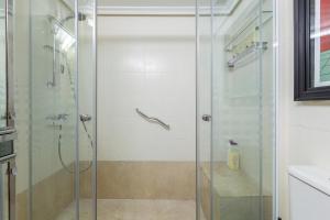 a glass shower in a bathroom with a sink at Cute apartment oceanfront in Benalmádena +17 photos